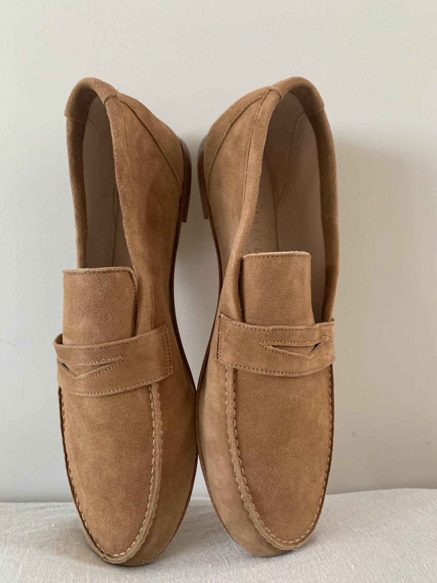 The Penny Loafer in Clove Suede against wall
