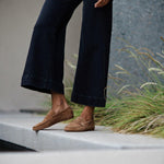 The Penny Loafer in Clove Suede on Figure Standing on Ledge