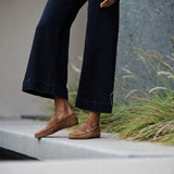 The Penny Loafer in Clove Suede on Figure Standing on Ledge
