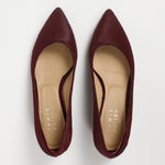 A pair of pointed-toe flat shoes in burgundy suede, shown from a top-down view on a light gray background. The insoles are beige with the brand name 'JAMIE HALLER' printed vertically.