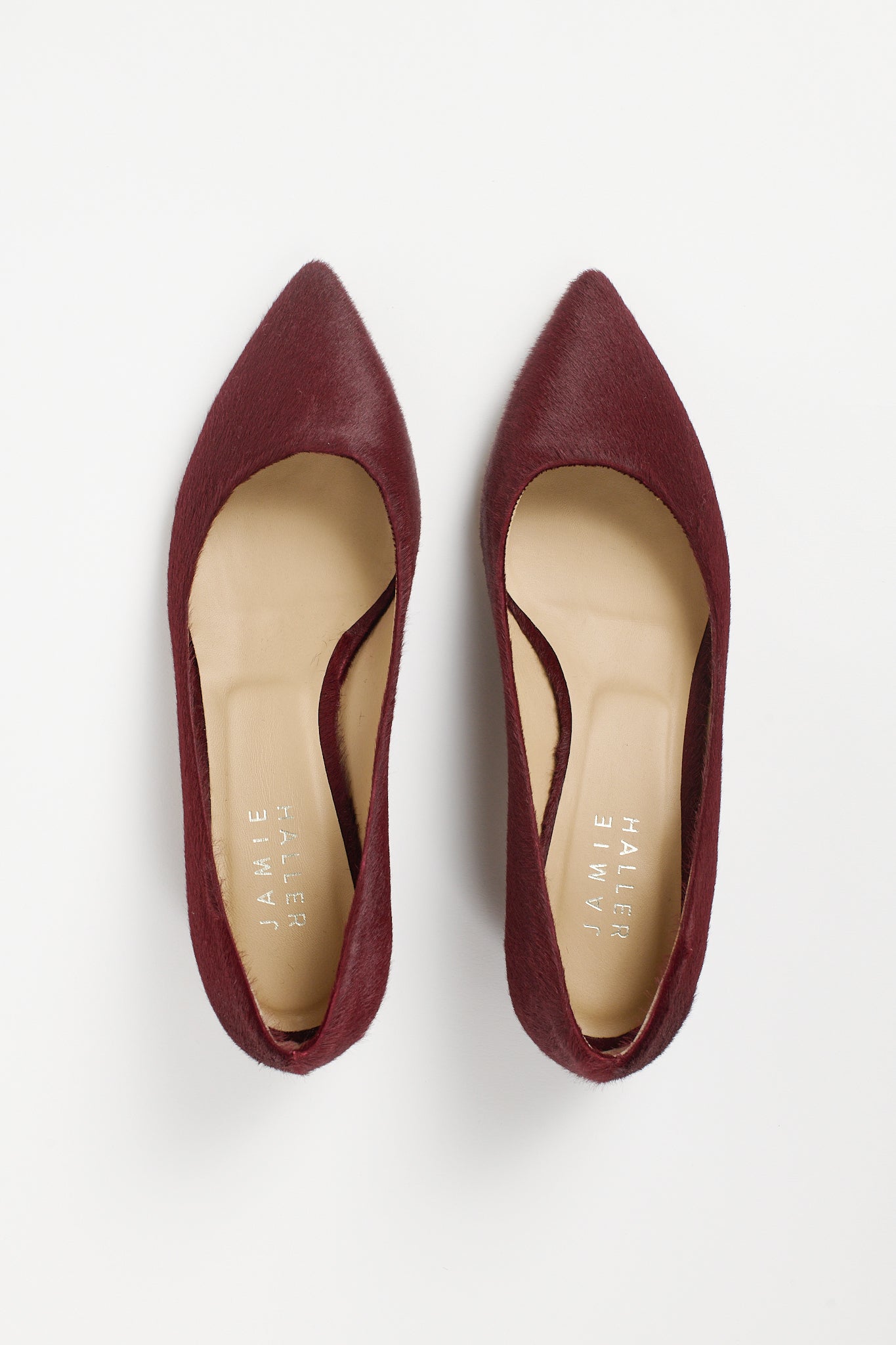 Top view of Jamie Haller claret ponyhair pointed toe kitten heel pumps with cream leather insoles and elegant cutout sides