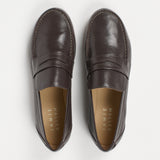 pair of grey penny loafers on a white background