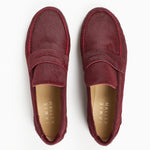 Top view of Jamie Haller claret burgundy ponyhair penny loafers with classic vamp straps, leather insoles, and rounded toes on a white background