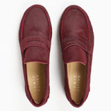 Top view of Jamie Haller claret burgundy ponyhair penny loafers with classic vamp straps, leather insoles, and rounded toes on a white background