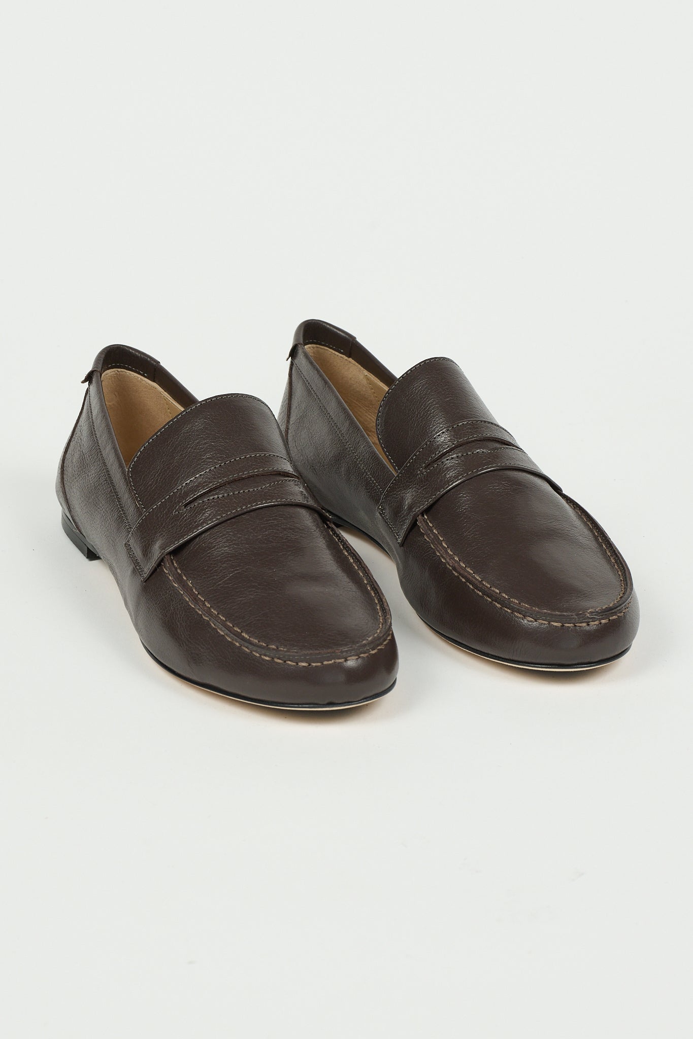 pair of loafers with a white background
