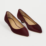 A pair of pointed-toe low-heel pumps in deep burgundy suede, shown from a high-angle view on a clean white background. The brand name 'Jamie Haller' is visible on the beige insoles.
