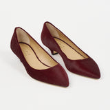 Jamie Haller claret ponyhair pointed kitten heel pumps with slim heels, almond shaped toes, and leather soles, shown as a pair on a white background