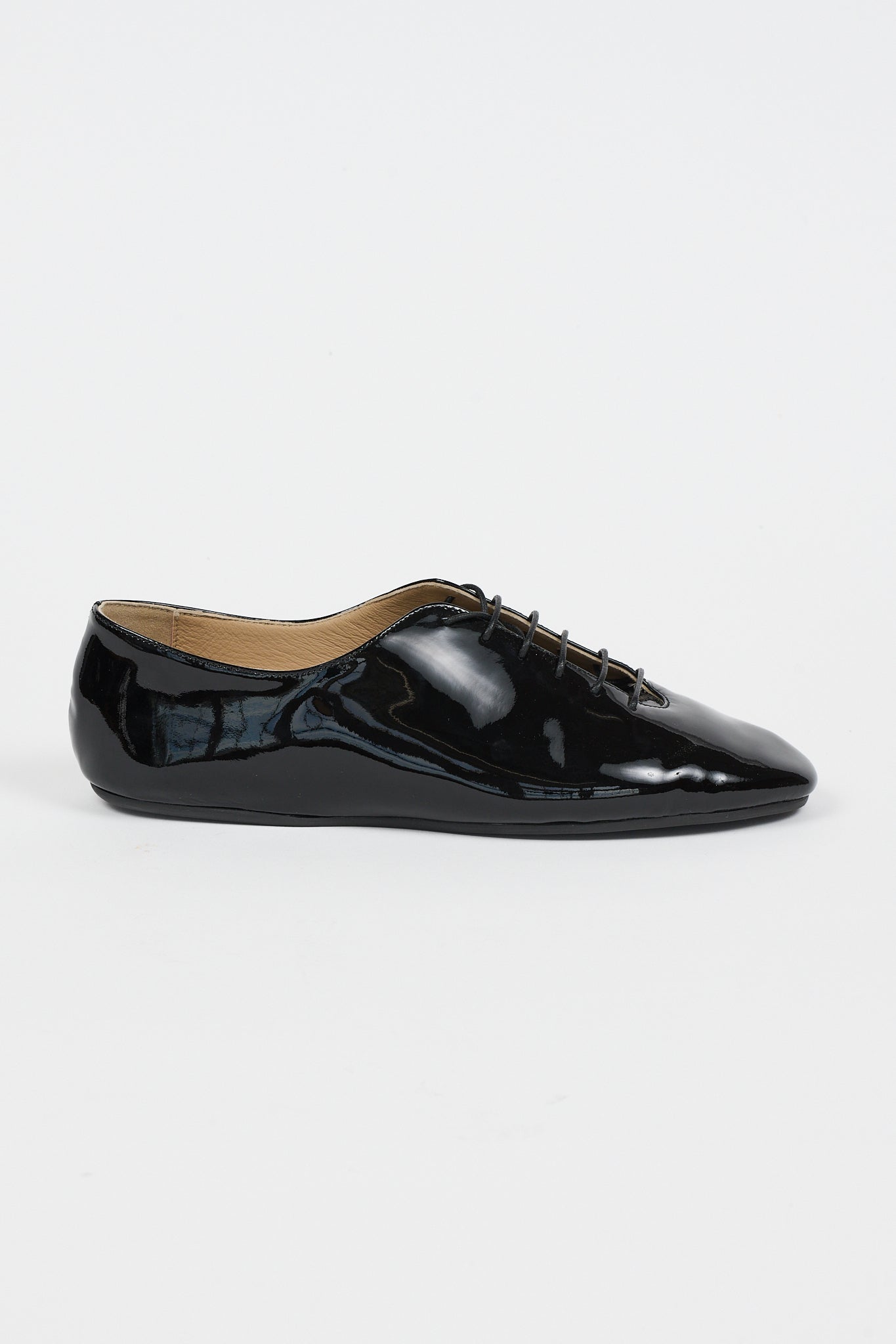 single side profile of a black shoe on a white background