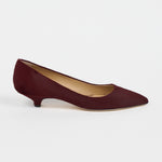 A single black woven Mary Jane flat shoe with a braided strap and pointed toe, shown in profile against a light gray background.