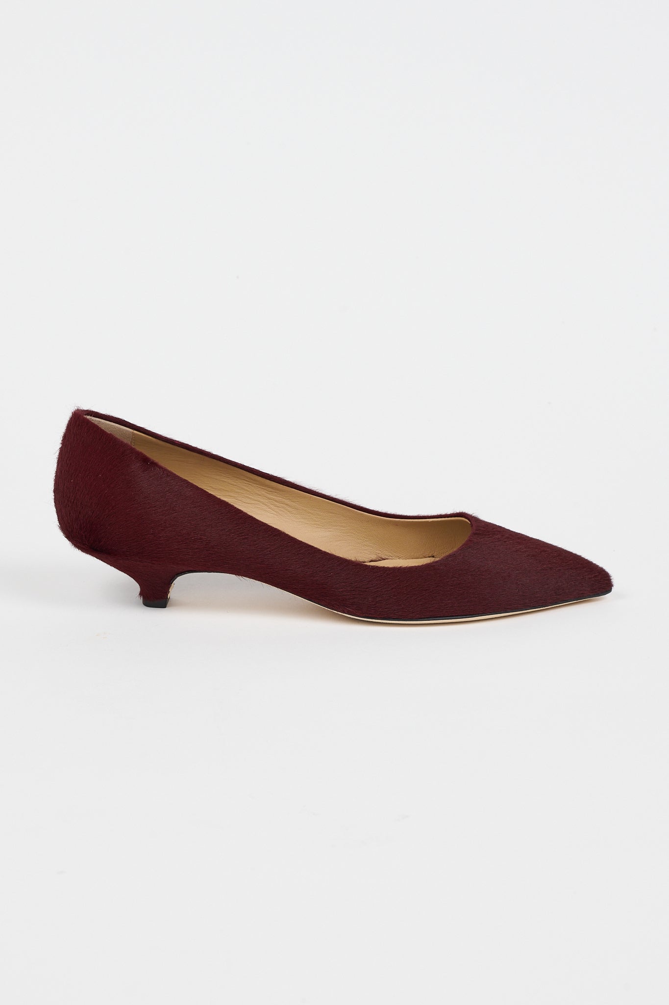 A single black woven Mary Jane flat shoe with a braided strap and pointed toe, shown in profile against a light gray background.