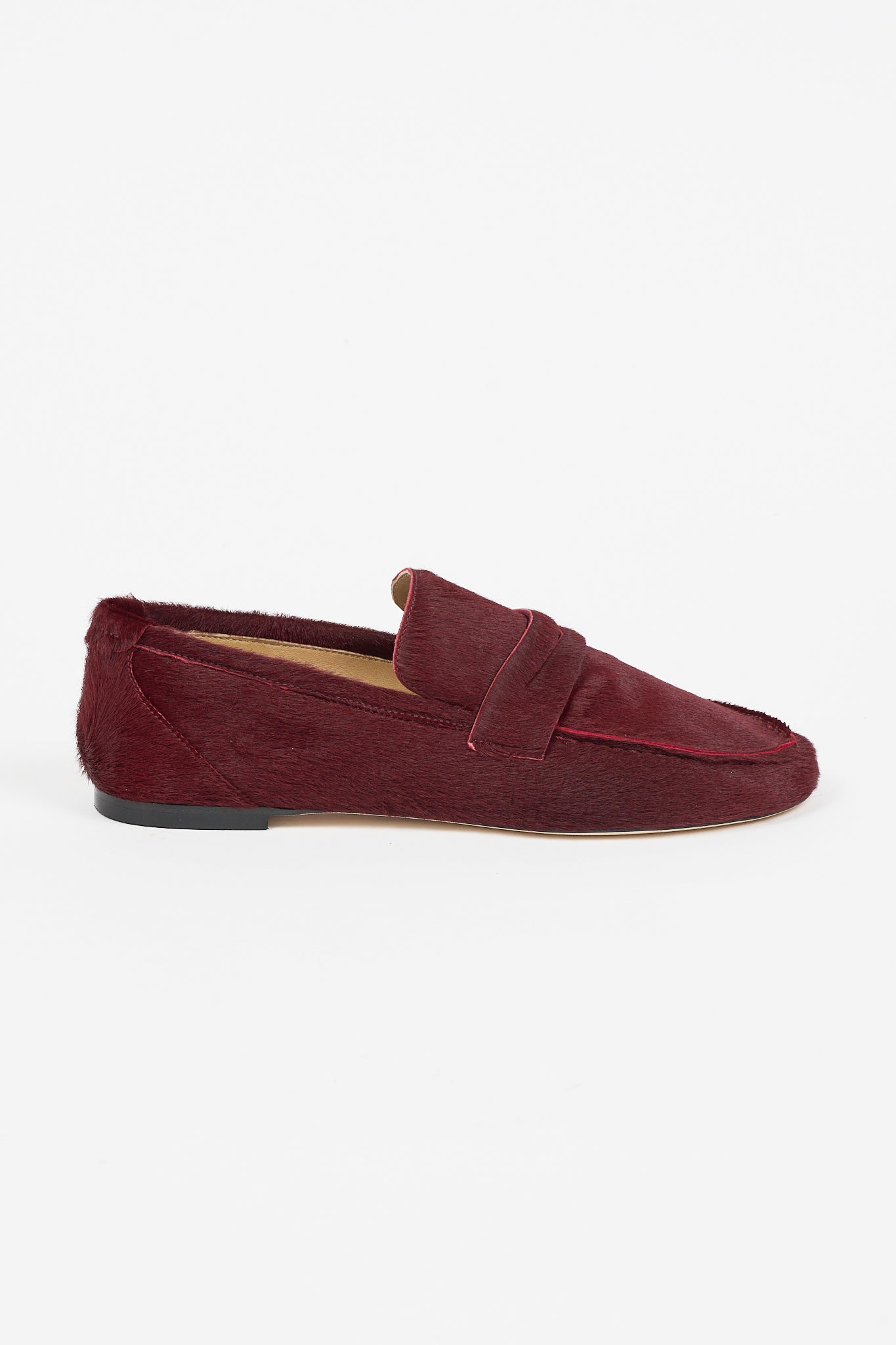 Side view of the Jamie Haller Penny Loafer in rich claret ponyhair, featuring a penny strap, moccasin toe, and low slip resistant sole
