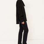 Person wearing a black outfit with a white background