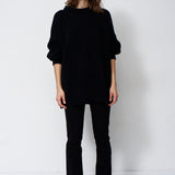 model wearing black sweater and black jeans