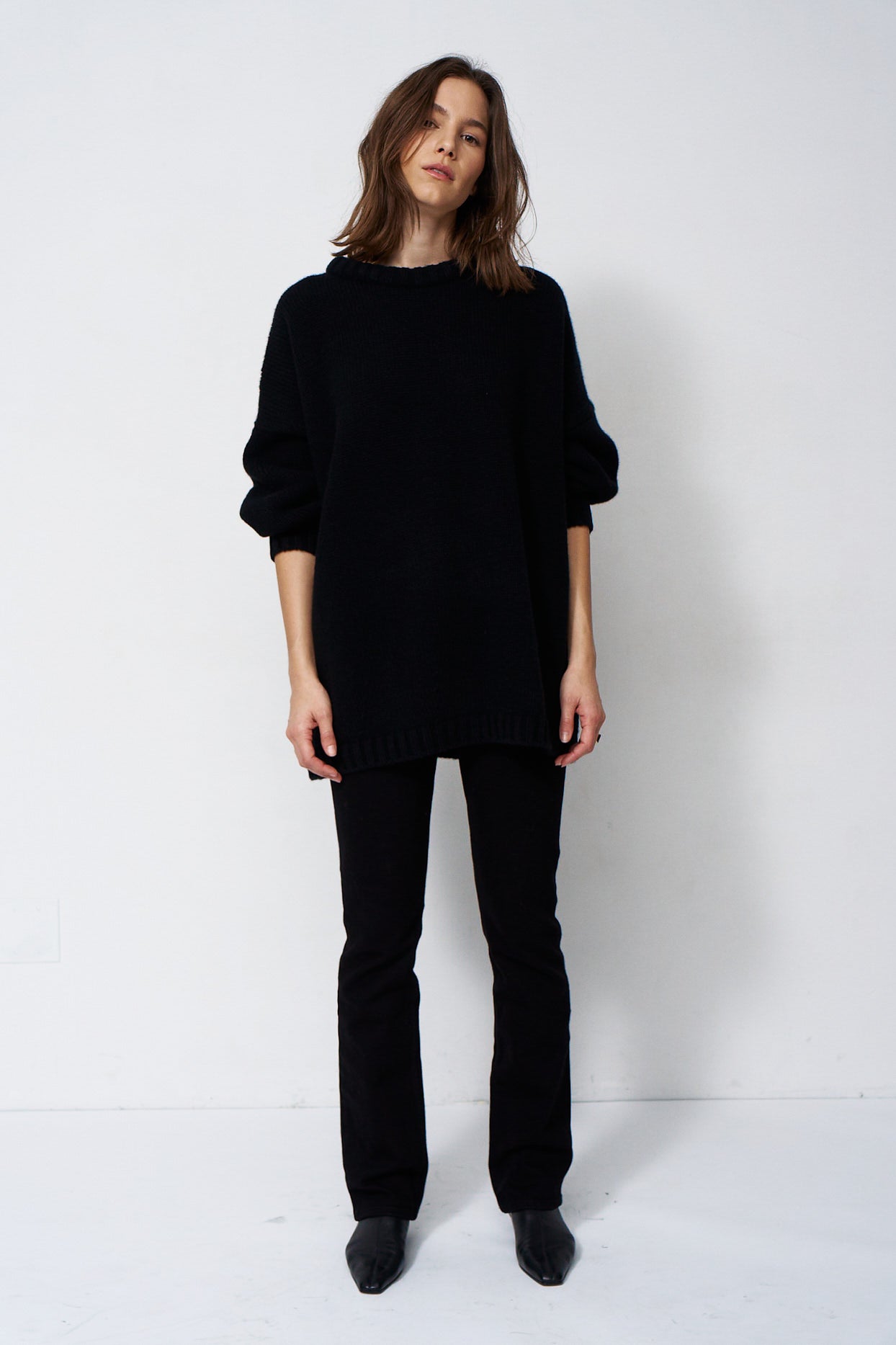model wearing black sweater and black jeans