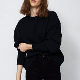 woman in all black with a white background