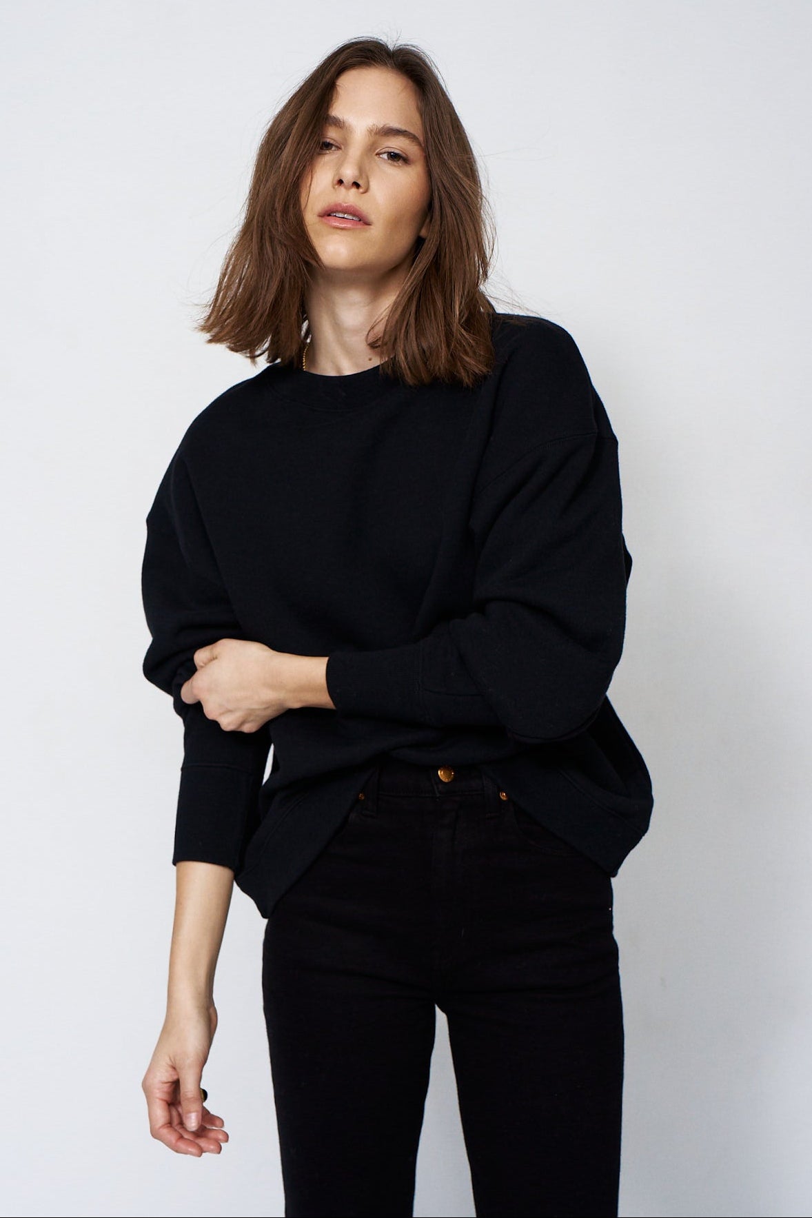 woman in all black with a white background