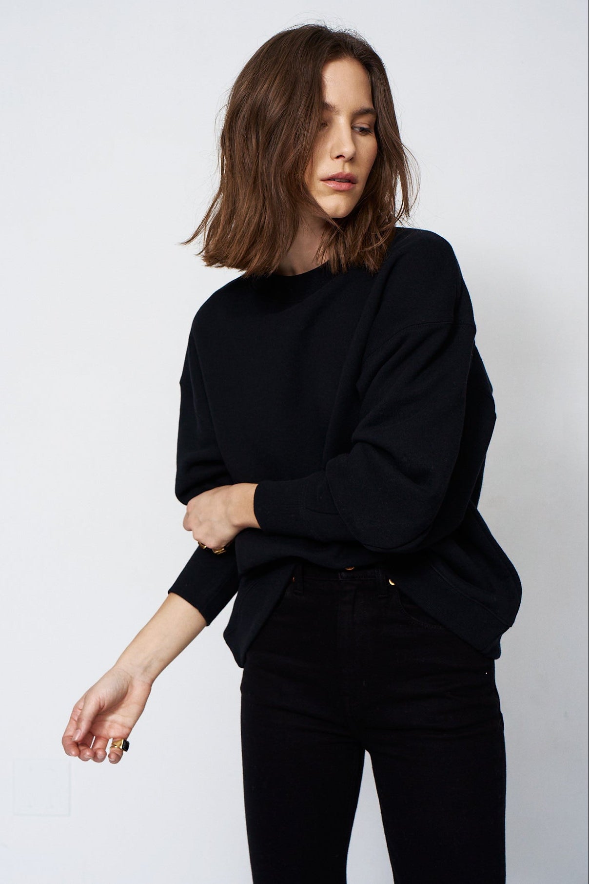 woman in all black with a white background