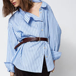off the shoulder blue shirt belted on a woman
