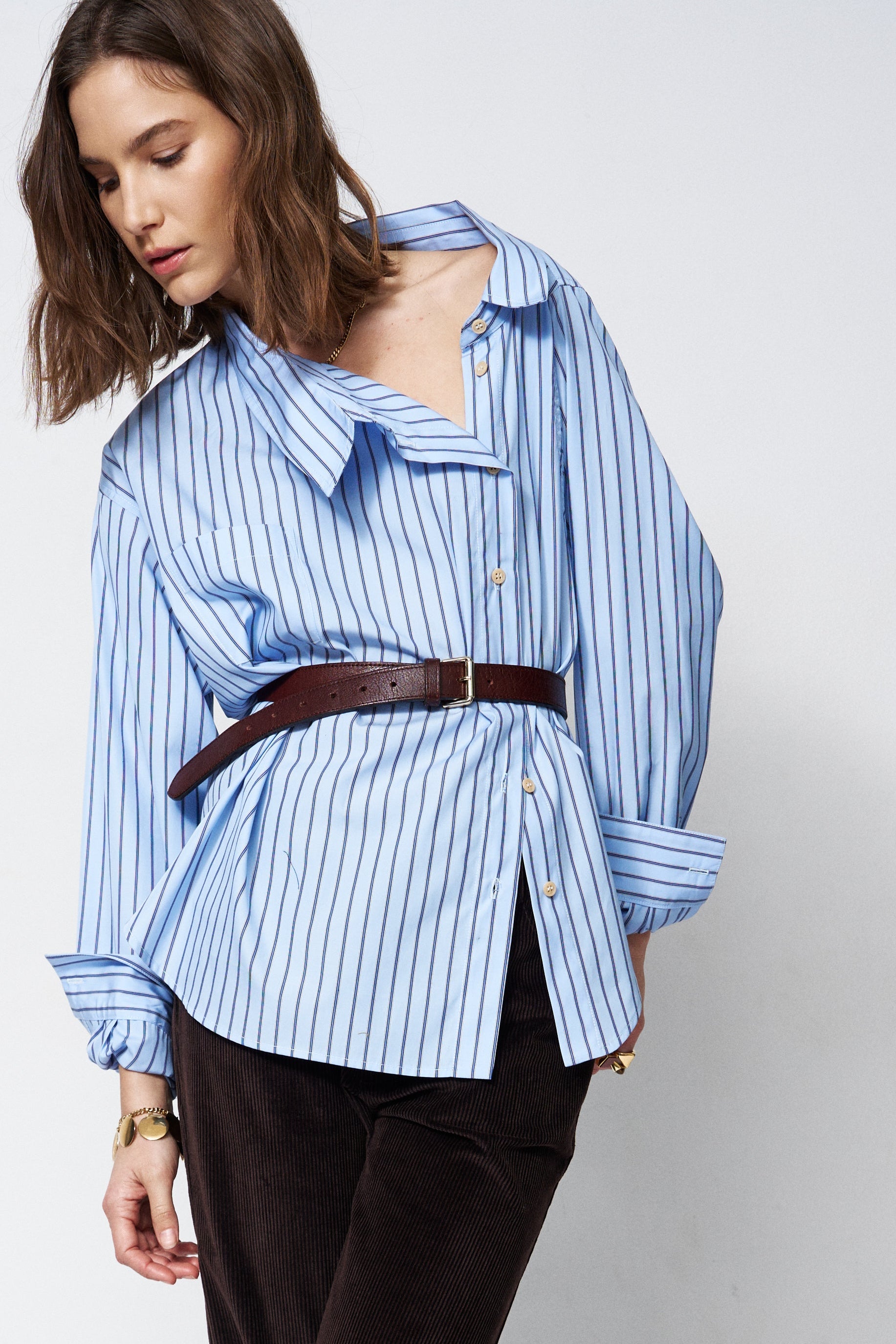 off the shoulder blue shirt belted on a woman
