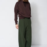 model standing in a sweatsuit in front of a white wall