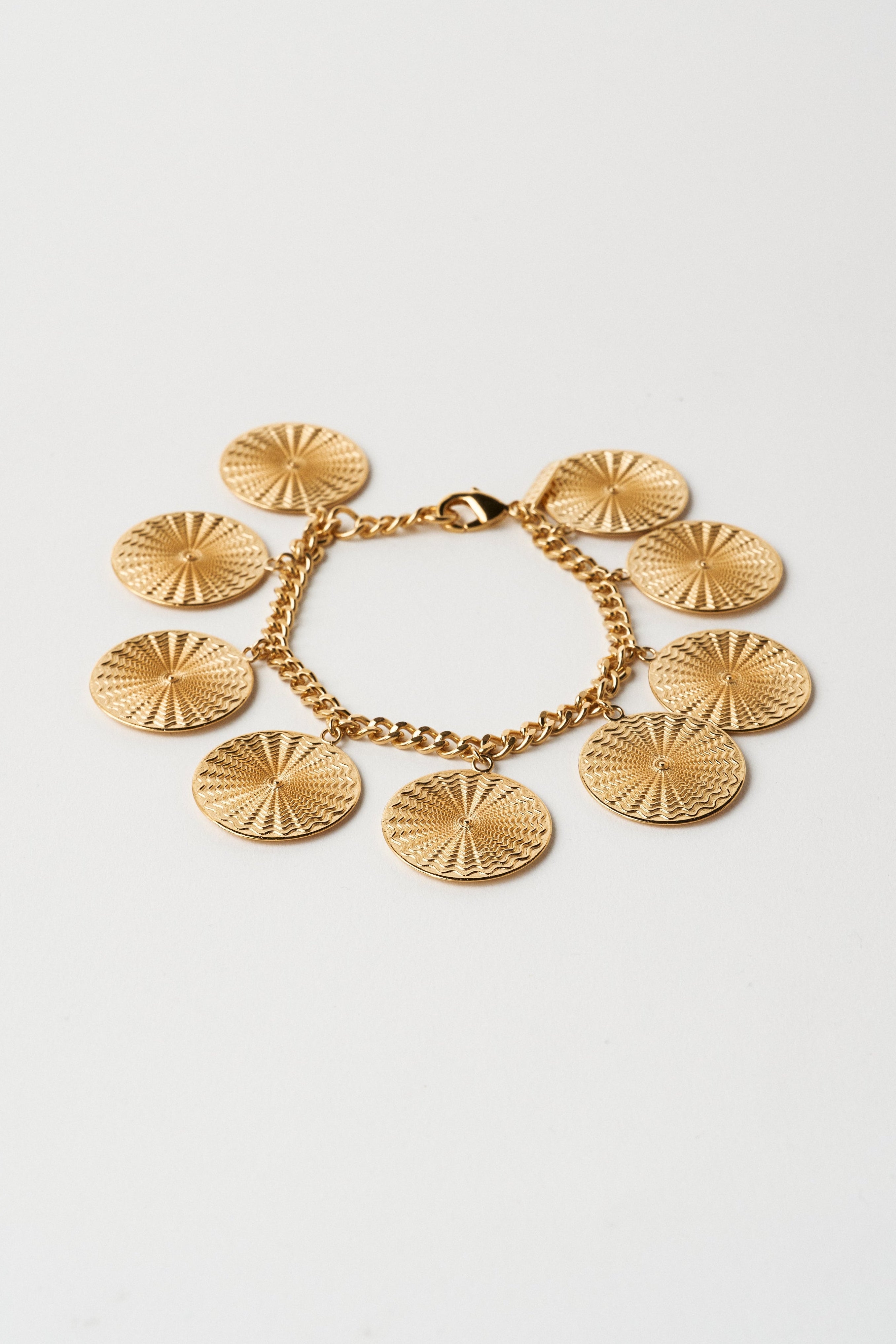 The Chaos Sunburst Charm Bracelet in Gold