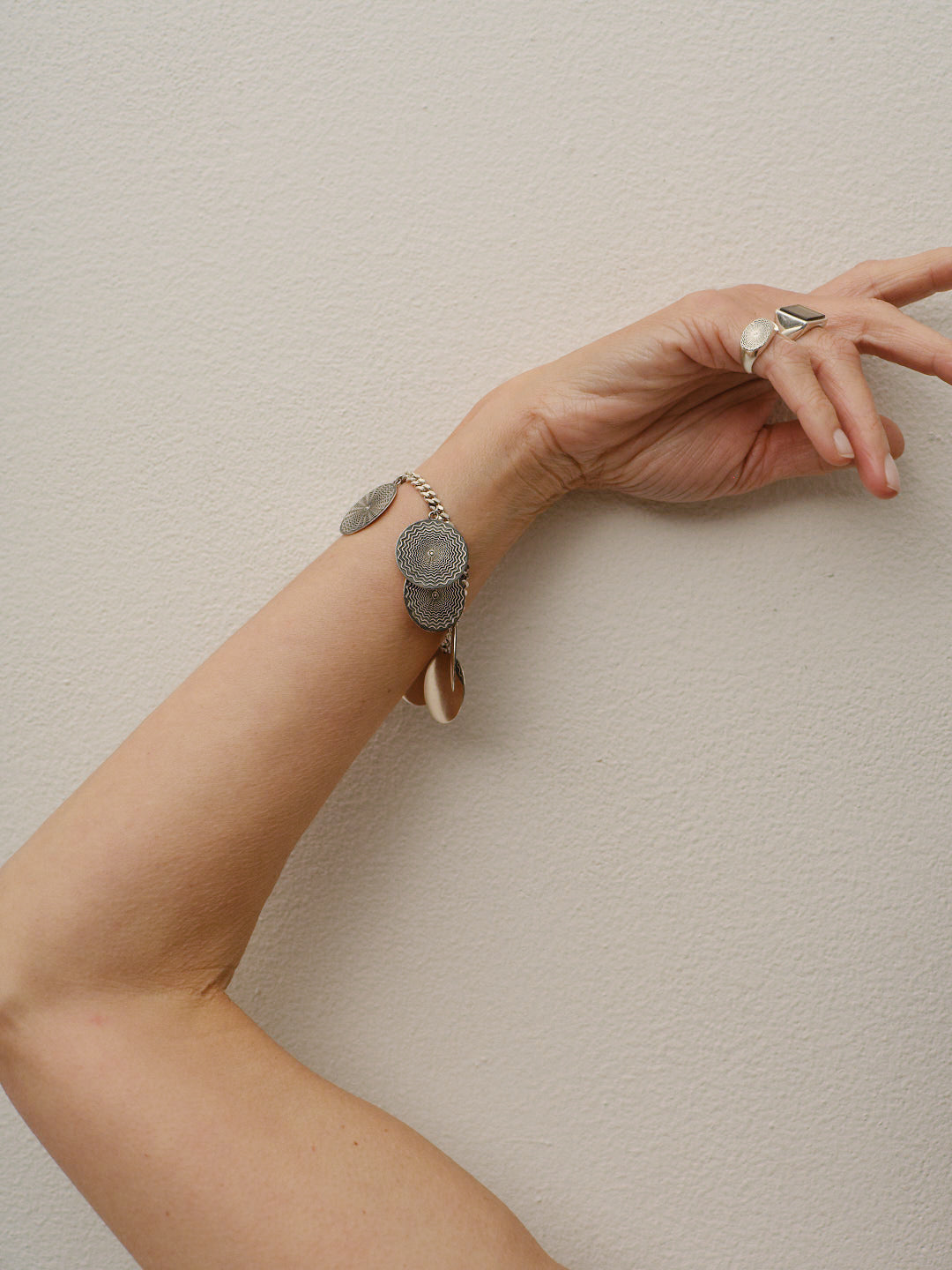 The Chaos Sunburst Charm Bracelet in Sterling Silver