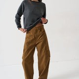 Woman wearing a Jamie Haller Deep Grey Daily Sweatshirt, brown cargo pants, and red sneakers.