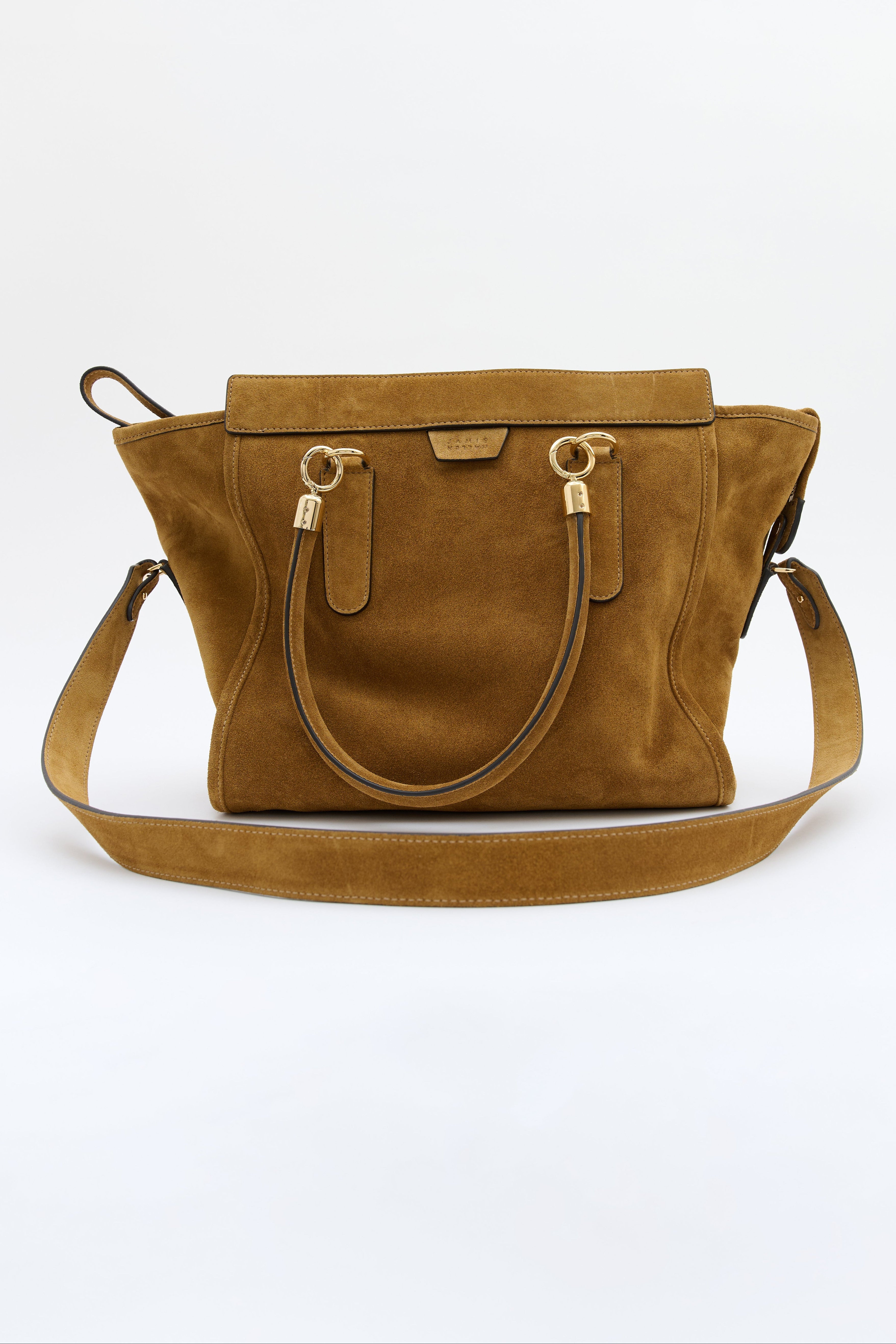 A tan suede handbag with gold-tone hardware, featuring dual top handles and a detachable shoulder strap, photographed against a plain white background.