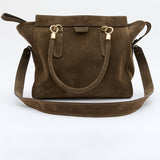 A dark brown suede handbag with gold-tone hardware and a matching shoulder strap, displayed against a clean white background.
