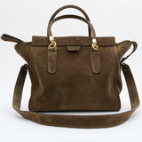 An olive suede handbag with gold-tone hardware, featuring dual top handles and a detachable shoulder strap, photographed against a clean white background.