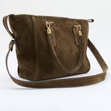 A dark brown suede shoulder bag with gold-tone hardware and a matching shoulder strap, photographed on a clean white studio background.