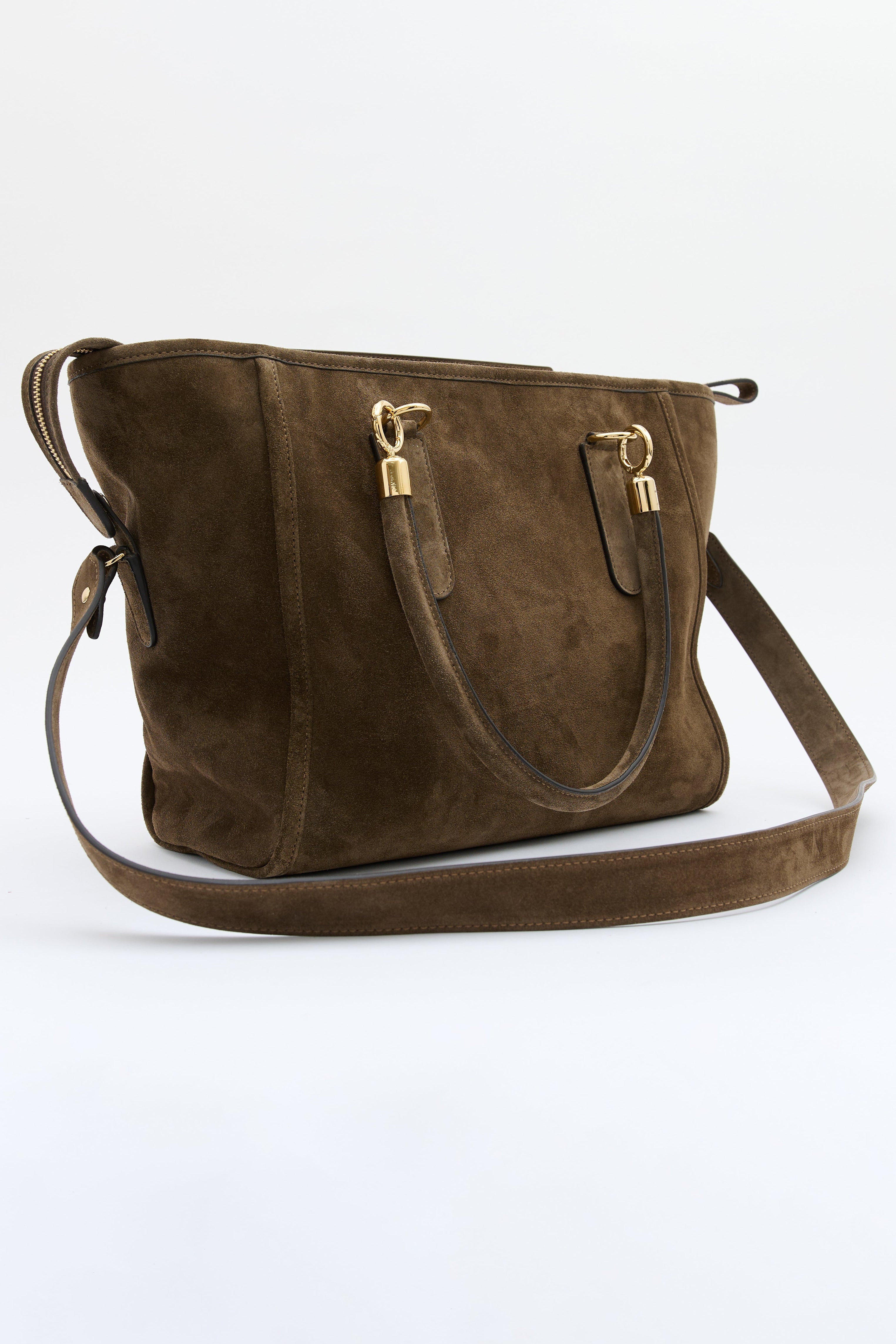 A dark brown suede shoulder bag with gold-tone hardware and a matching shoulder strap, photographed on a clean white studio background.
