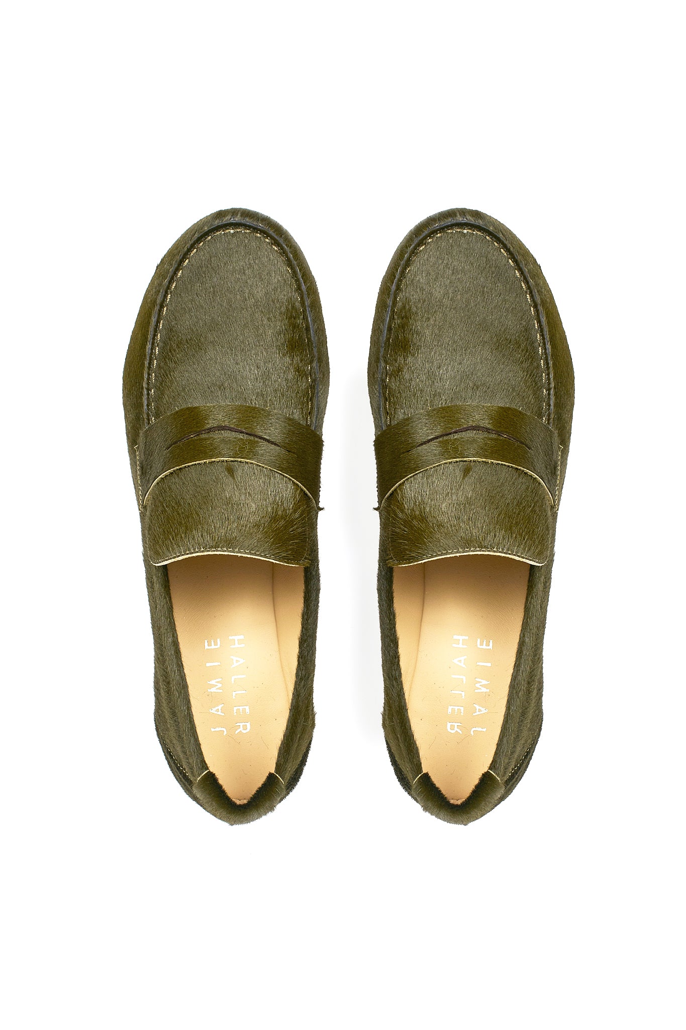 Top view of Jamie Haller moss green ponyhair penny loafers with classic strap detail, leather soles, and soft tan insoles on a white background