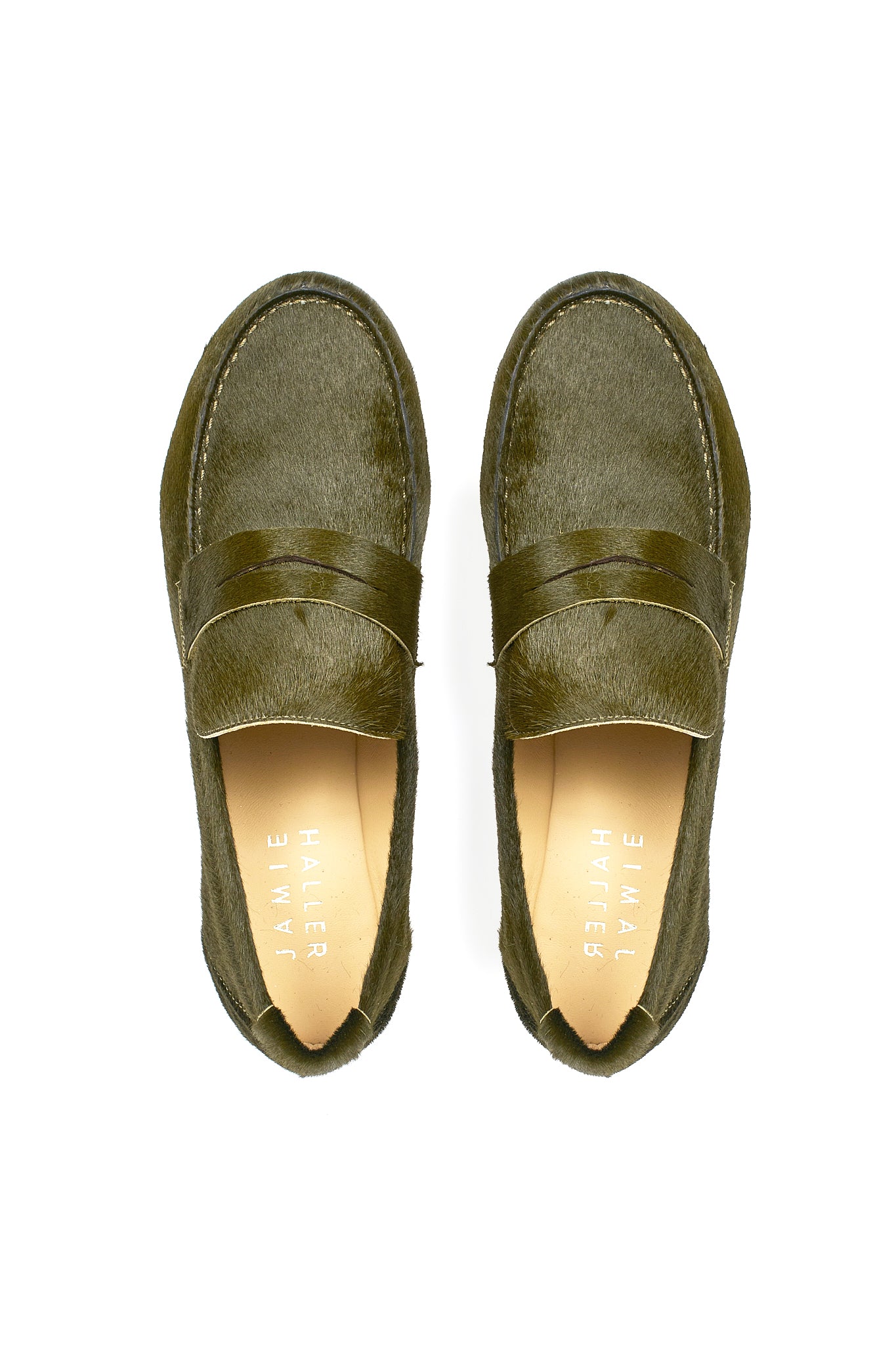 Top view of Jamie Haller moss green ponyhair penny loafers with classic strap detail, leather soles, and soft tan insoles on a white background