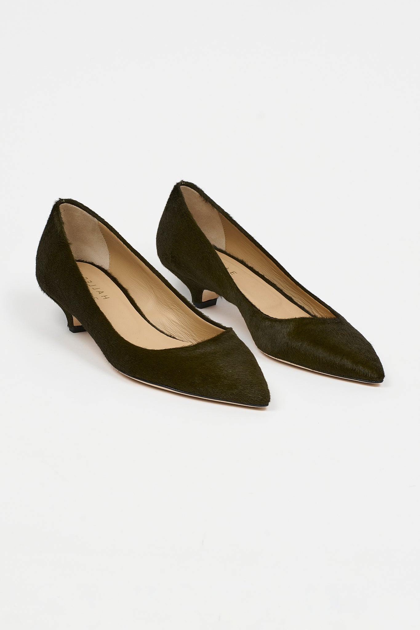 A pair of dark olive green pointed-toe pumps with kitten heels, shown on a clean white background.