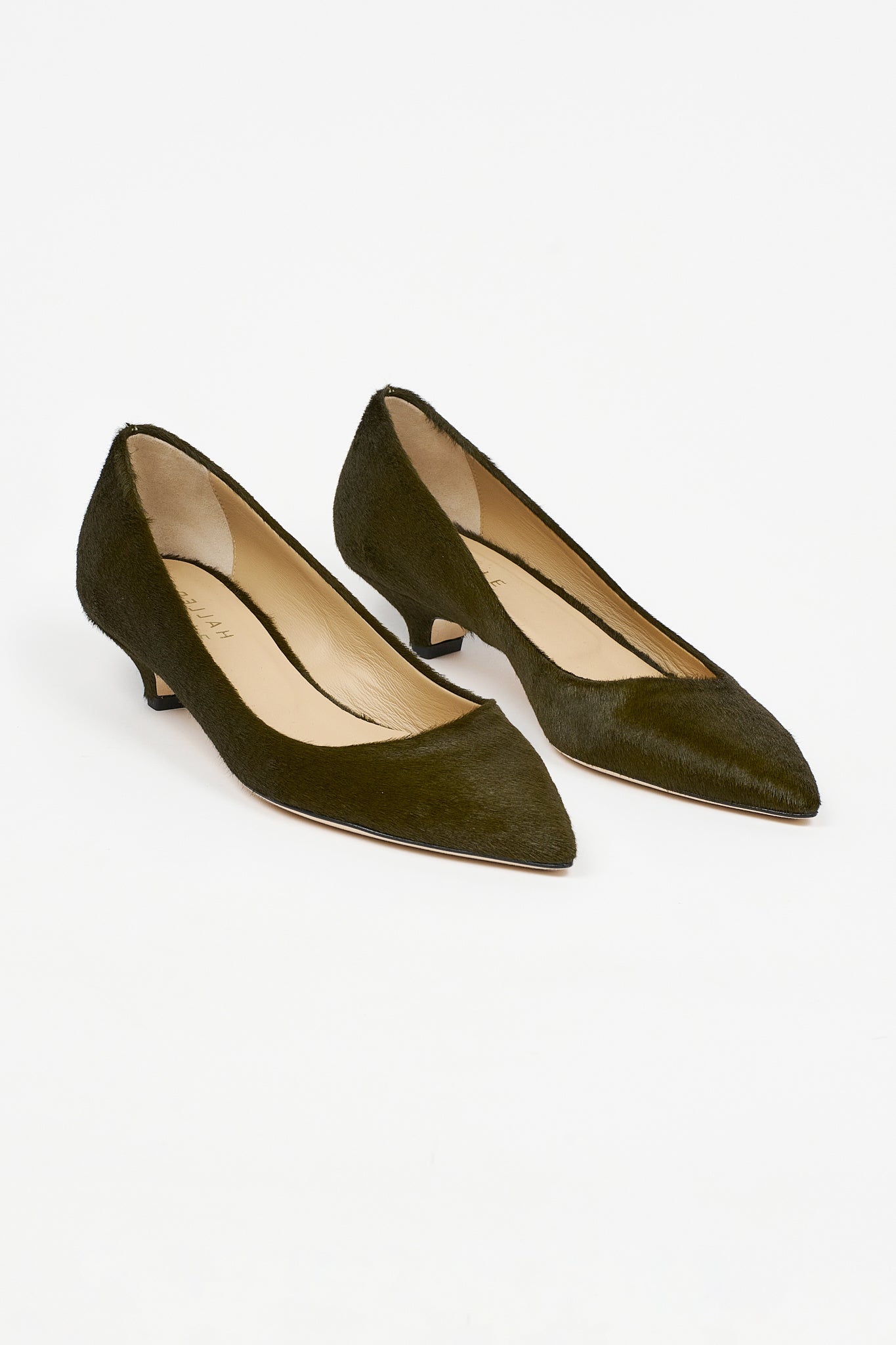 Jamie Haller moss ponyhair kitten heel pumps with pointed toes, soft leather insoles, low heels, and sleek polished silhouettes shown as a pair