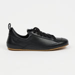 one black leather sneaker in front of white background