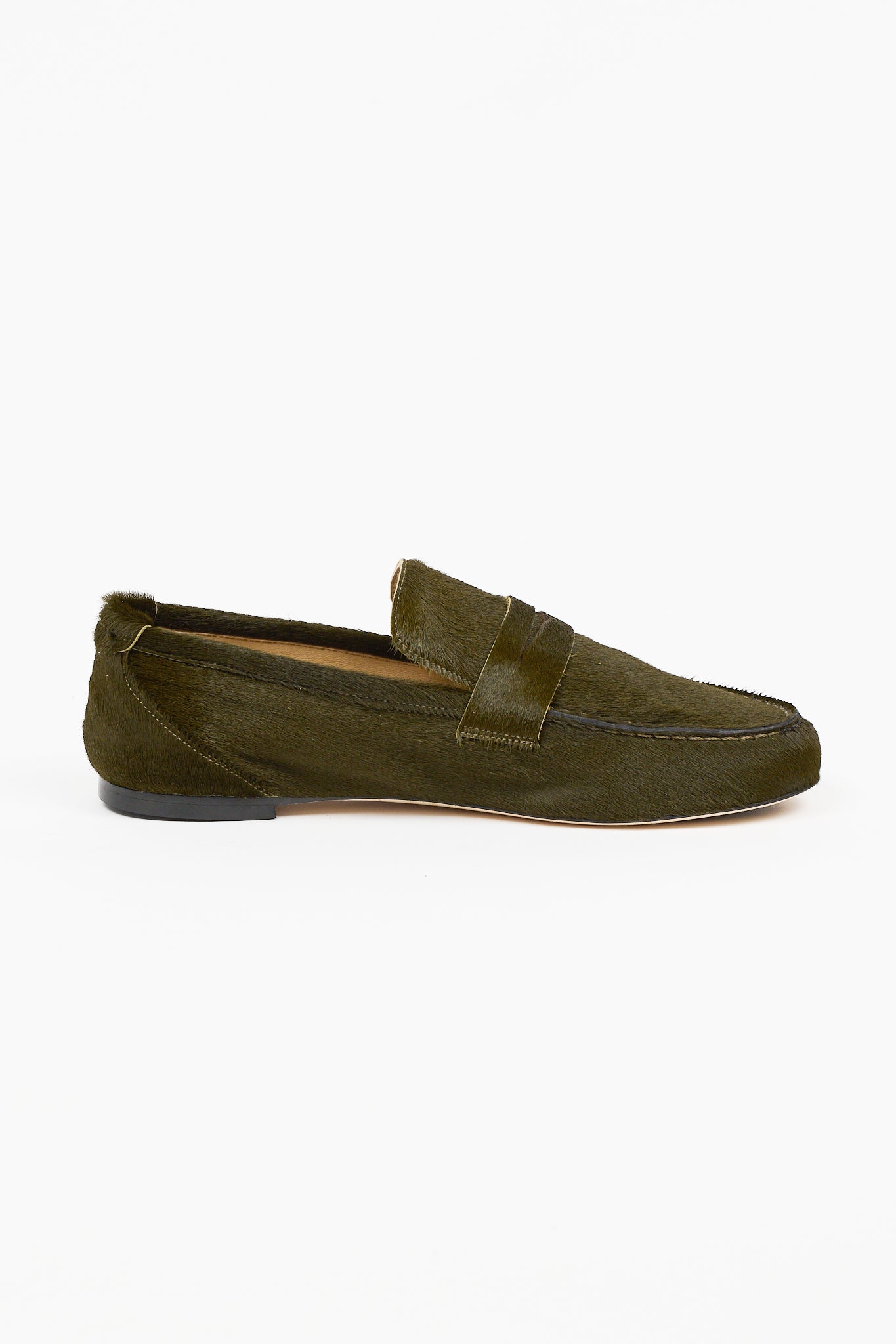 Olive green ponyhair penny loafer by Jamie Haller shown in side profile with a stitched moc toe vamp low stacked heel and leather sole