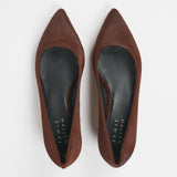 A pair of pointed-toe flat shoes in brown suede, shown from a top-down view on a light gray background. The insoles are black with the brand name 'JAMIE Haller' printed in white.