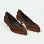 A pair of women's pointed-toe pumps in dark brown textured suede or hair-on-hide, shown on a clean white background.