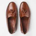 A pair of brown leather tassel loafers shown from a top-down view on a clean white background.