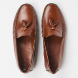 A pair of brown leather tassel loafers shown from a top-down view on a clean white background.
