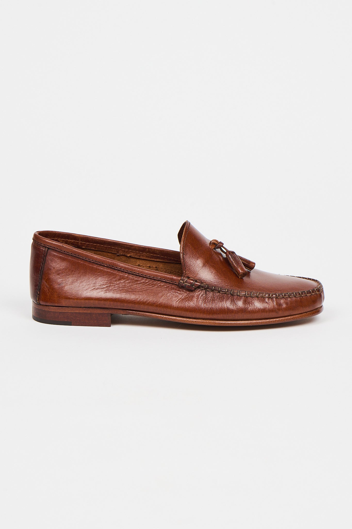 brown leather loafers on a white background