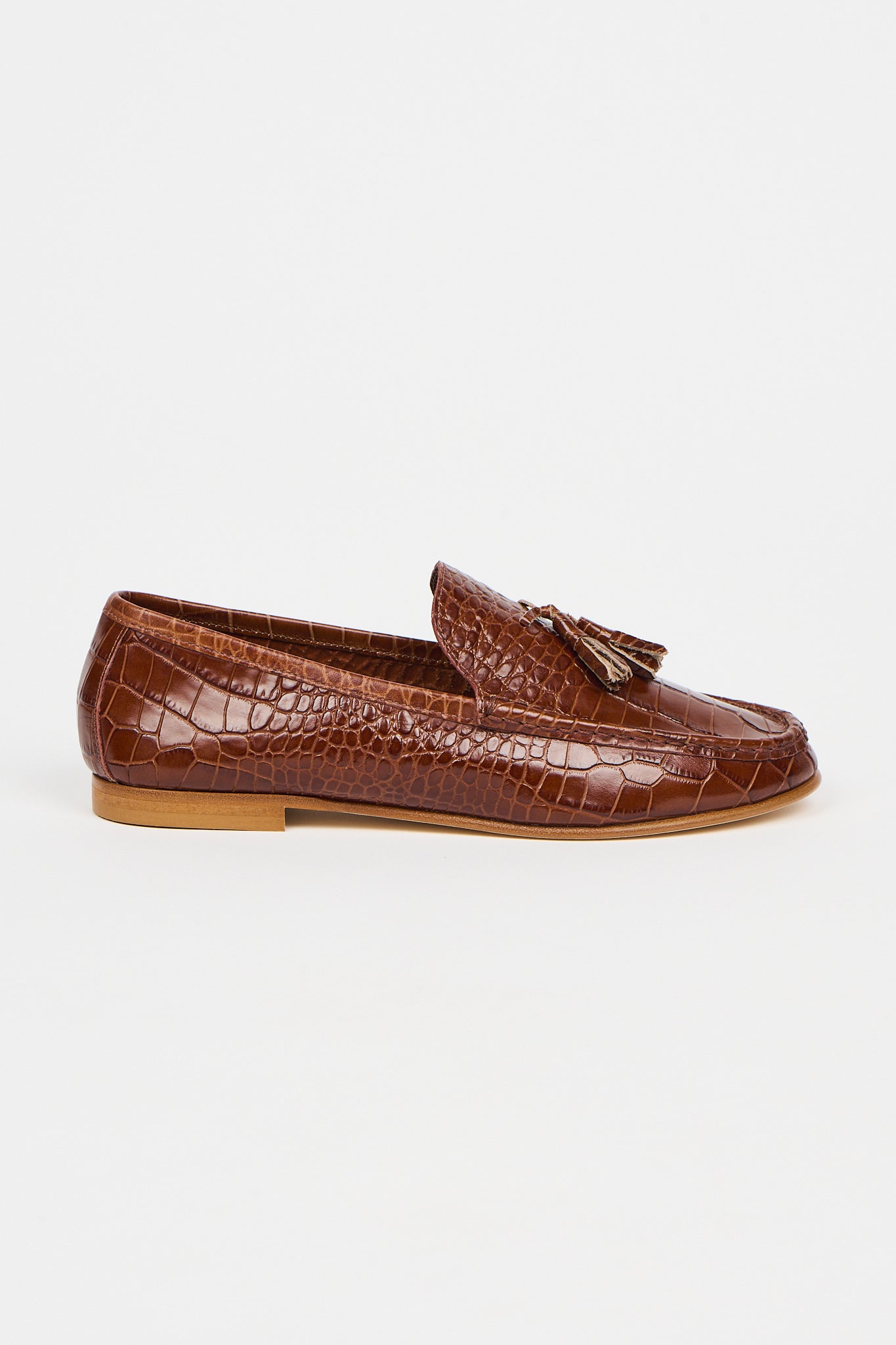 brown loafers on a white background