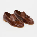 brown loafers with white sole on a white background