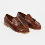 brown loafers with white sole on a white background