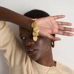 The Chaos Sunburst Charm Bracelet in Gold