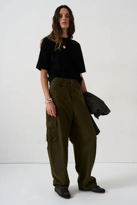 woman in black tee in front of a white background
