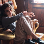 The Penny Loafer in Croc Black on Body Sitting in Chair