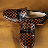 Black and Brown Woven Loafer Flat View on Top of Green Couch
